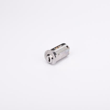 Runt cylinderlås i silverfärgad metall med en nyckelöppning på ena sida.