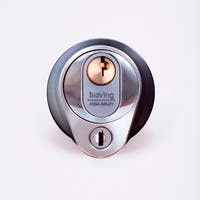 Närbild av ett silverfärgat säkerhetslås med två nyckelhål, placerade ovanför varandra.