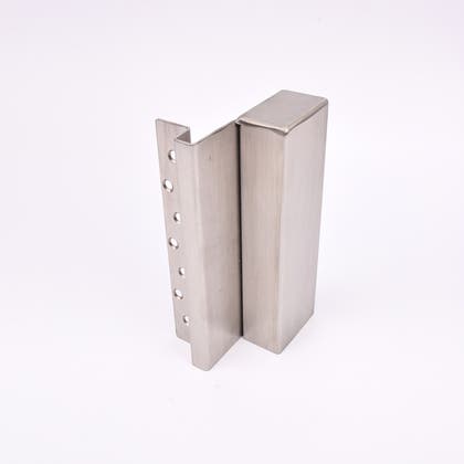 En L-formad nyckelförvaringsenhet med flera cirkulära hål längs ena sidan.