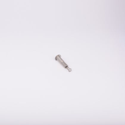 En metallisk cylinderformad komponent med en fjäder som sticker ut från ena änden.