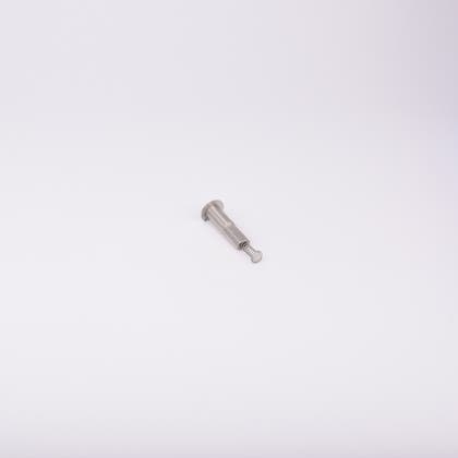 En metallisk cylinderformad komponent med en fjäder som sticker ut från ena änden.