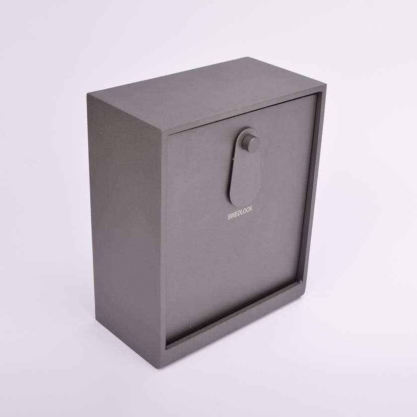 Grått fasadnyckelskåp i metall med vridbar skyddskåpa.