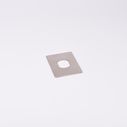 En rektangulär metallplatta med hål i mitten.