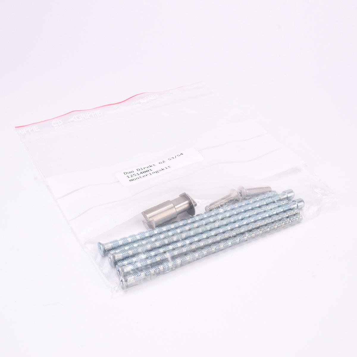 Monteringssats bestående av brickor och skruvar som ligger i en plastpåse.