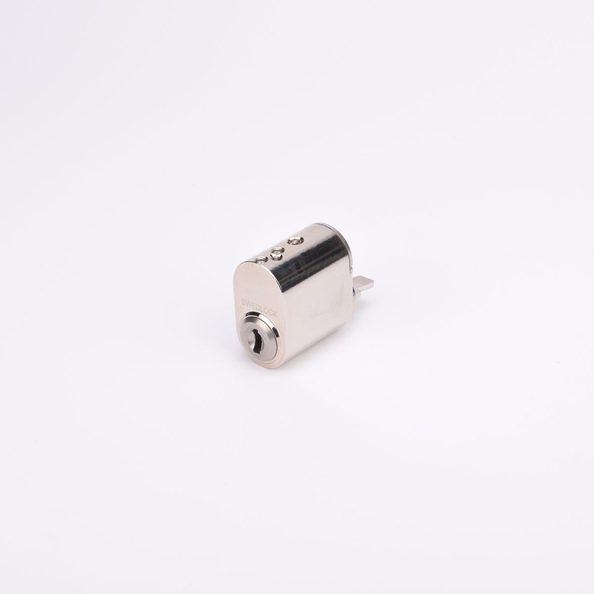 Oval låscylinder i silverfärgad metall med en kort, platt, räfflad metall medbringare.