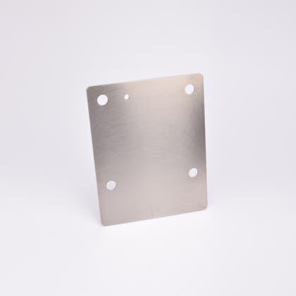 Rektangulär metallplatta med fyra runda hål.