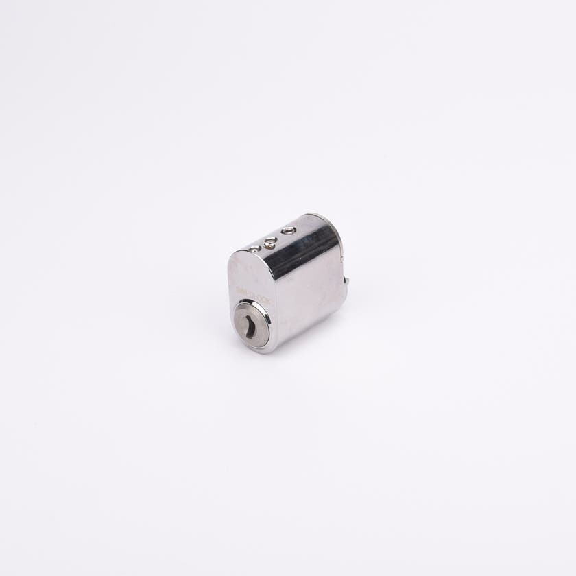 Liten cylindrisk låskolv i metall med blank yta.