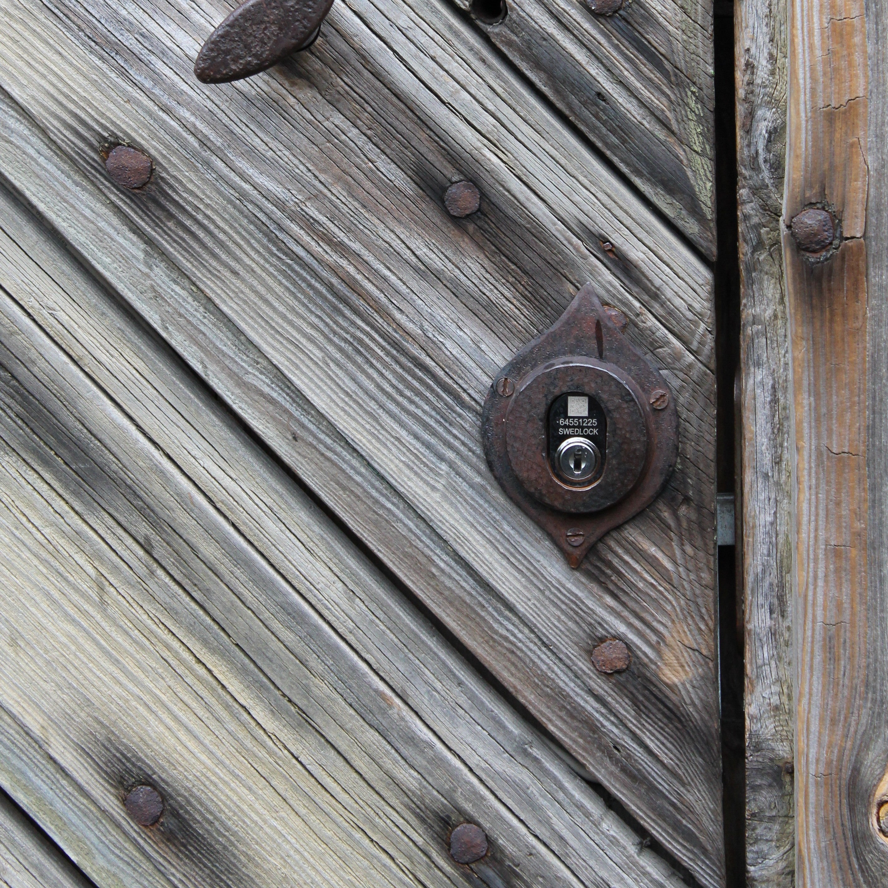 Bild på Swedlocks digitala cylinder på en grind