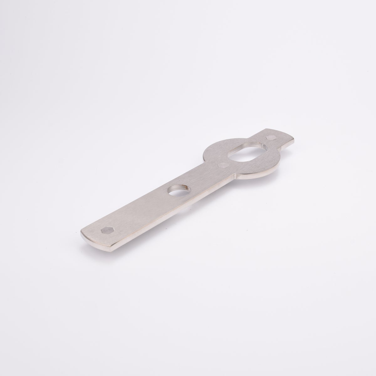 Metalliskt platta med platt, avlång kropp, ovalt urtag vid toppen och ett runt vid mitten.