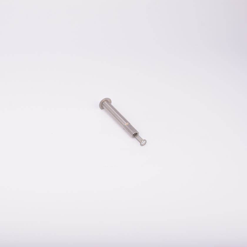 En metallisk cylinderformad komponent med en fjäder som sticker ut från ena änden.