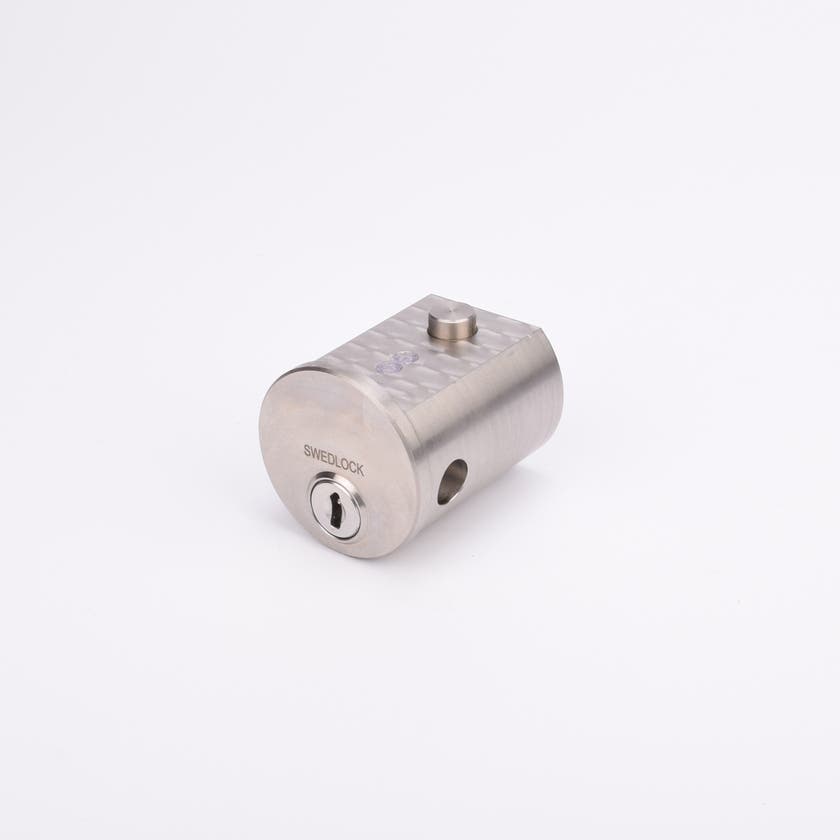 Cylindrisk silverfärgad metallisk låscylinder med nyckelhål.