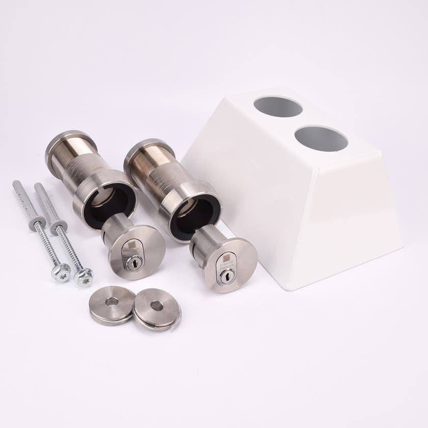 Två cylinderformade rör med två cylindriska lås i rostfritt stål, två skruvar, två runda metallbrickor och ett vitt trapphusfäste i metall med två hål.